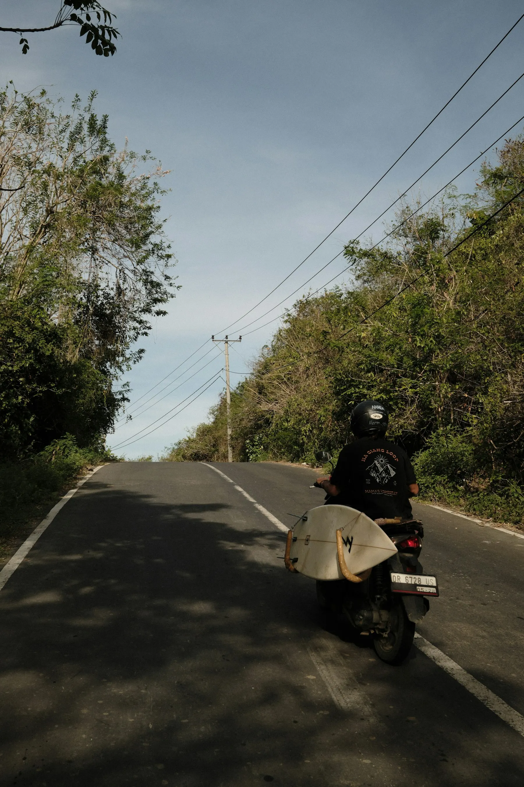 A scooter on an open road through the Bali countryside