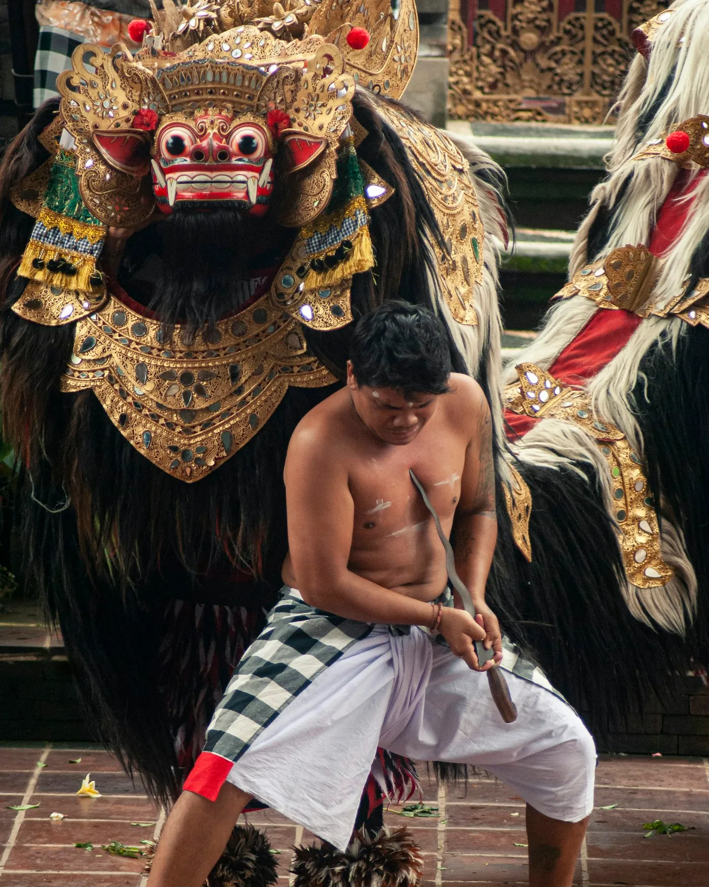 Barong and a kris dancer during the temple drama