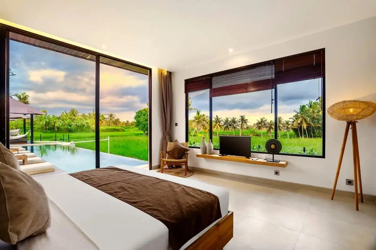 A bedroom opening to the pool deck, the rice terraces at last light