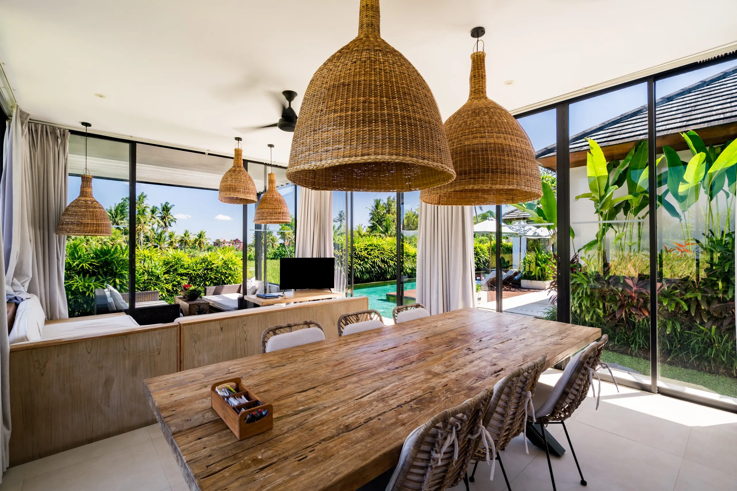 The dining table under woven lanterns