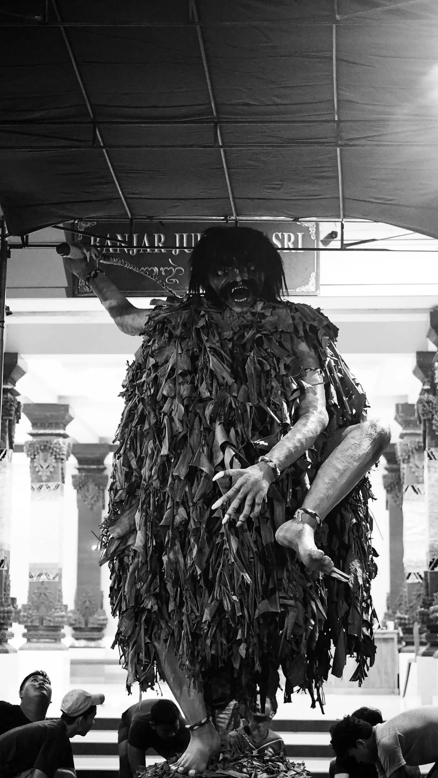 An ogoh-ogoh effigy paraded through the street after dark