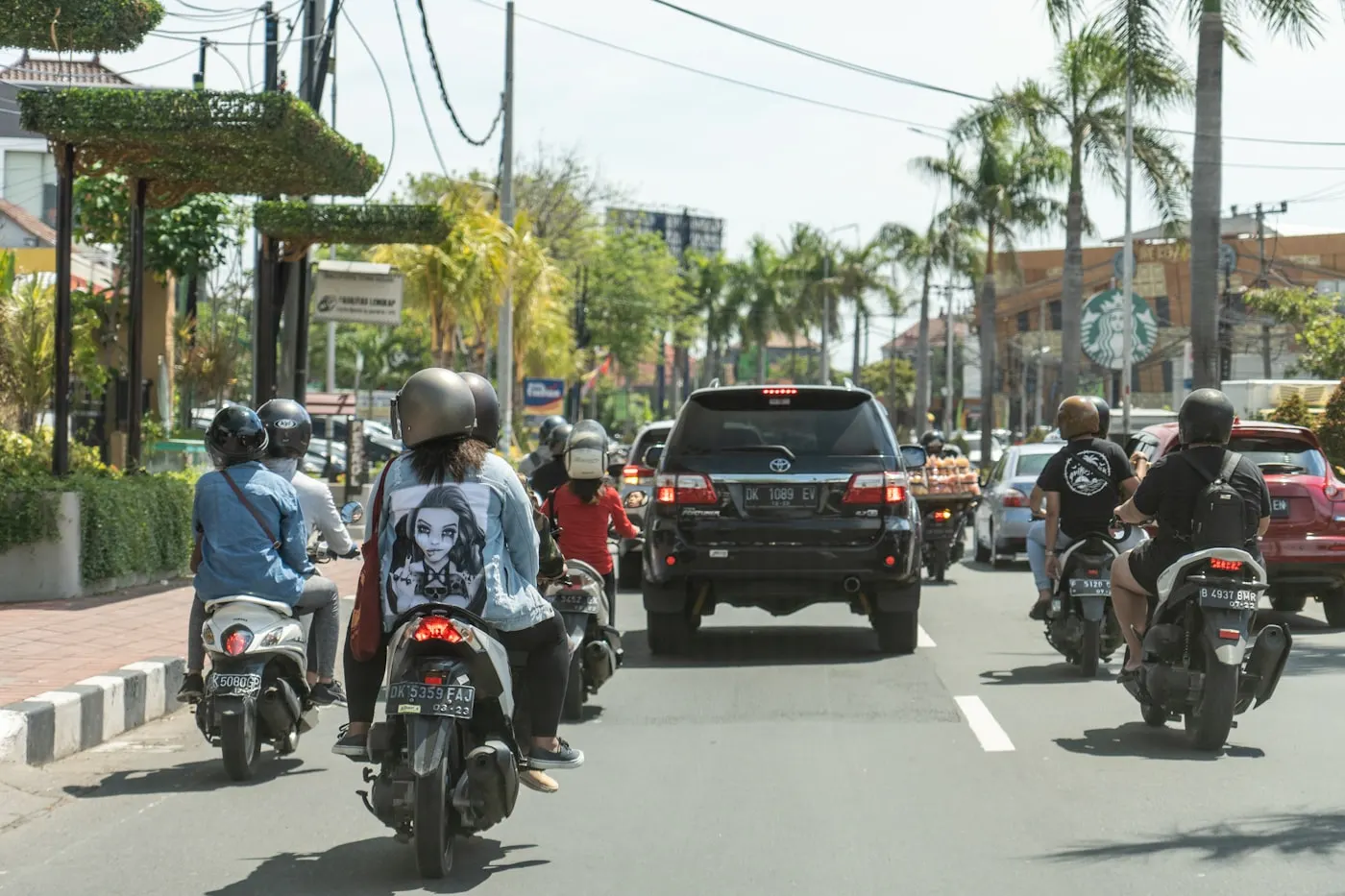 Scooters and cars sharing a road in Bali