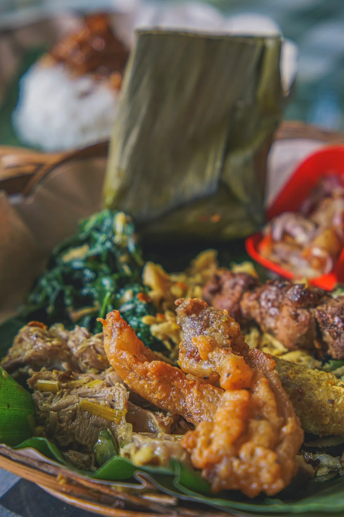A mixed rice plate served on a banana leaf